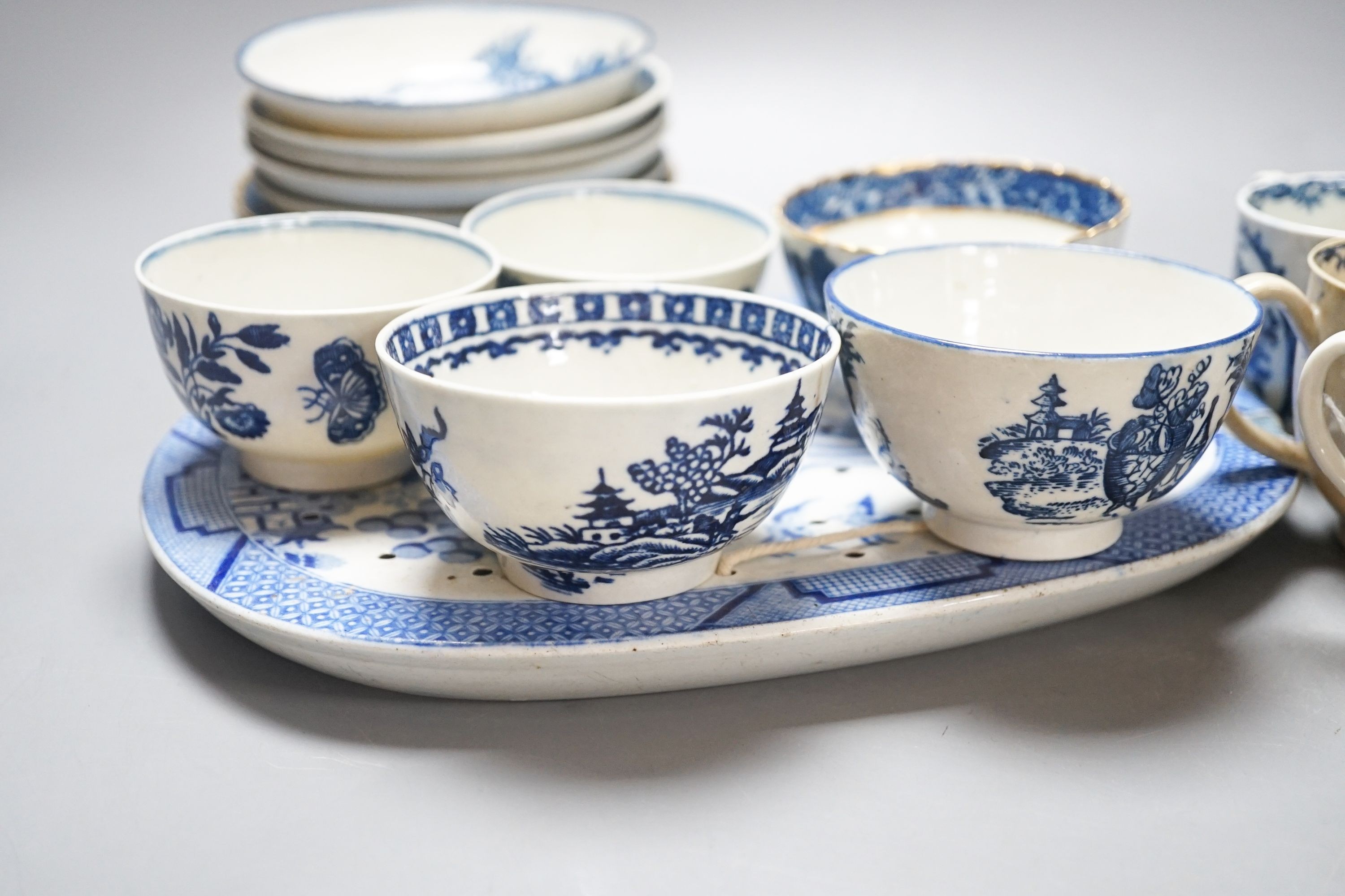 A group of Worcester and Caughley blue and white tea and coffee wares, late 18th century including fisherman pattern, three flowers pattern, chinoiserie figures etc.